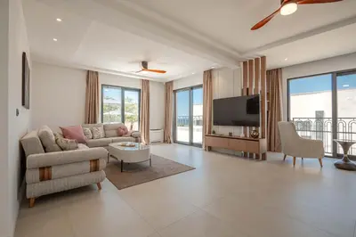 a living room with a couch and a tv at Luxury Villa - New Building with pool and Fantastic Side Sea View in Budva