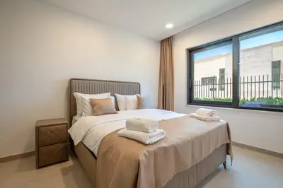 a bedroom with a large bed with towels on it at Luxury Villa - New Building with pool and Fantastic Side Sea View in Budva