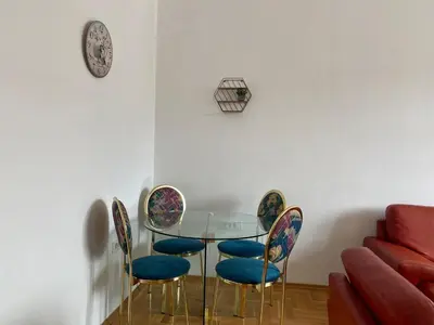 a dining room with a glass table and chairs at Heart of the city big 1BR on Independence square in Podgorica