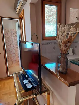 a television sitting on a counter in a kitchen at Heart of the city big 1BR on Independence square in Podgorica