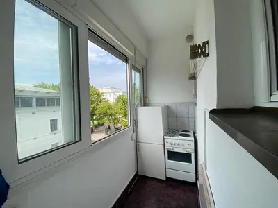a kitchen with a white refrigerator and a window at Heart of the city big 1BR on Independence square in Podgorica