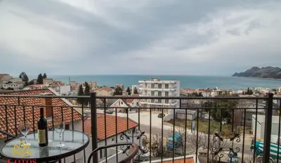 a balcony with a table and a view of a city at Lotos - stan 421 L2 in Dobra Voda