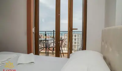 a room with a bed and a view of a balcony at Lotos - stan 421 L2 in Dobra Voda