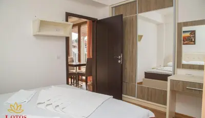 a hotel room with a bed and a mirror at Lotos - stan 421 L2 in Dobra Voda