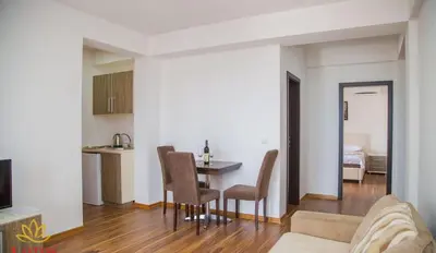 a living room and kitchen with a table and chairs at Lotos - stan 211 L2 in Dobra Voda