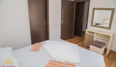 a bedroom with a white bed with a mirror at Lotos - stan 211 L2 in Dobra Voda