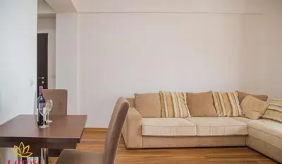 a living room with a couch and a table at Lotos - stan 211 L2 in Dobra Voda