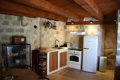 a kitchen with a white refrigerator and a stove at Unique stone apartment Villa M in Budva