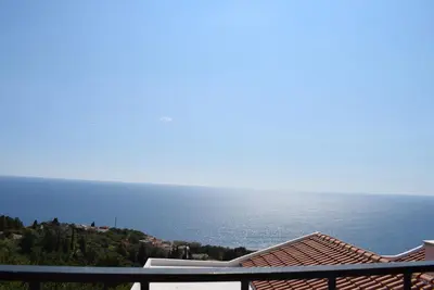 a view of the ocean from the balcony of a house at Unique stone apartment Villa M in Budva