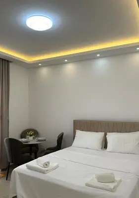a hotel room with a bed and a table with chairs at Garsonjera u centru Budve in Budva
