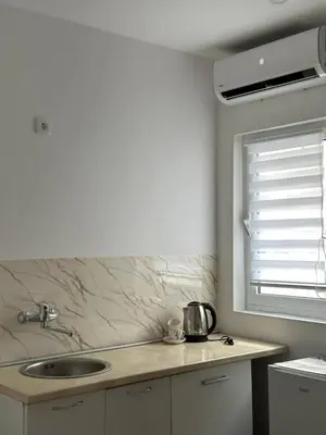a kitchen counter with a sink and a window at Garsonjera u centru Budve in Budva