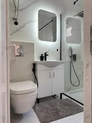 a bathroom with a toilet and a sink and a mirror at Garsonjera u centru Budve in Budva