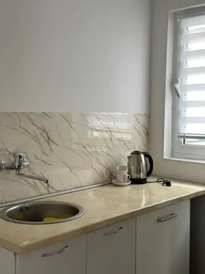 a kitchen counter with a sink and a window at Garsonjera u centru Budve in Budva