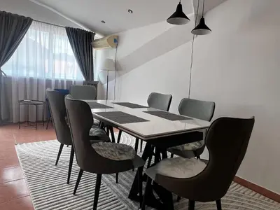 a dining room with a table and chairs at Apartment Zevs 5 in Budva