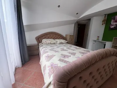 a bedroom with a bed with a quilt on it at Apartment Zevs 5 in Budva