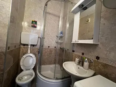 a bathroom with a toilet and a sink and a shower at Apartment Zevs 5 in Budva