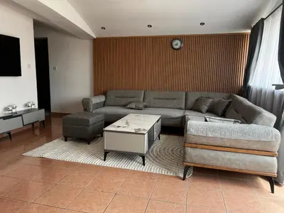 a living room with a couch and a table at Apartment Zevs 5 in Budva