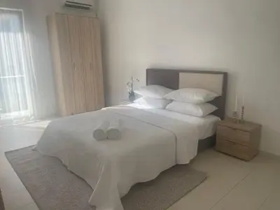 a bedroom with a large white bed with white pillows at Apartment Nimes in Ulcinj
