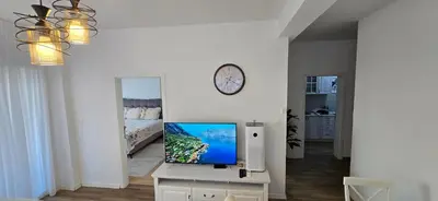 a living room with a flat screen tv on a table at Apartment Olive Nest in Budva