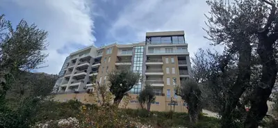 a tall building with a clock on top of it at Apartment Olive Nest in Budva