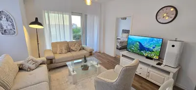 a living room with a couch and a flat screen tv at Apartment Olive Nest in Budva