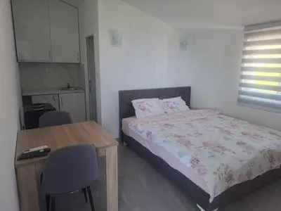 a bedroom with a bed and a table and a chair at Apartman Andjela 2 in Budva