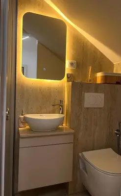 a bathroom with a sink and a toilet and a mirror at Apartmani Vanity Budva in Budva