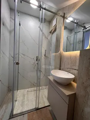 a bathroom with a glass shower and a sink at Apartmani Vanity Budva in Budva