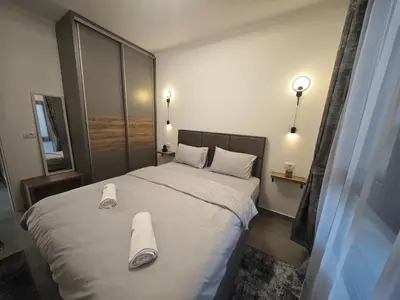 a bedroom with a large bed with towels on it at Etno Lux Isaković in Ulcinj