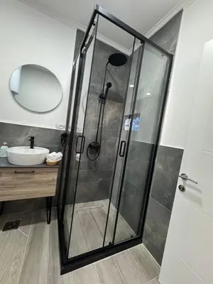 a shower with a glass door in a bathroom at Etno Lux Isaković in Ulcinj