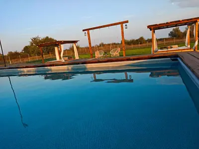 a swimming pool with two chairs and a swing at Etno Lux Isaković in Ulcinj