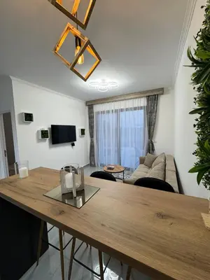 a living room with a table and a couch at Etno Lux Isaković in Ulcinj