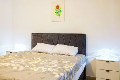 a bedroom with a bed with a black headboard at Brazos Apartment in Kotor