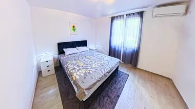 a white bedroom with a bed and a window at Brazos Apartment in Kotor