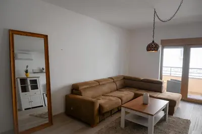 a living room with a brown couch and a mirror at Adriatic Escape -Modern Sea View Apartment,Special Summer Deal in Pržno