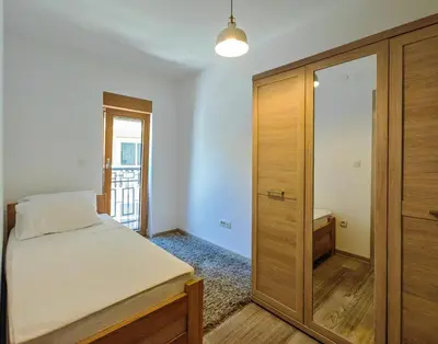 a bedroom with a bed and a wooden cabinet at Adriatic Escape -Modern Sea View Apartment,Special Summer Deal in Pržno