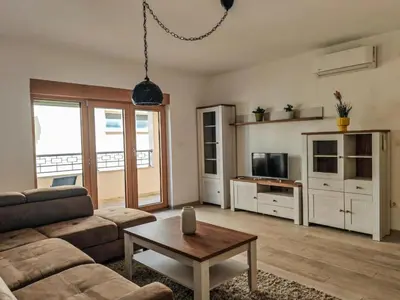 a living room with a couch and a table at Adriatic Escape -Modern Sea View Apartment,Special Summer Deal in Pržno