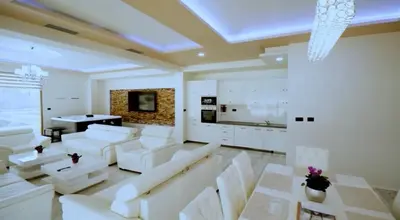 a living room with white couches and a table at Apartment Matej 2 in Budva