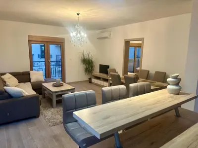 a living room with a table and a couch at The Coastal Charm in Pržno