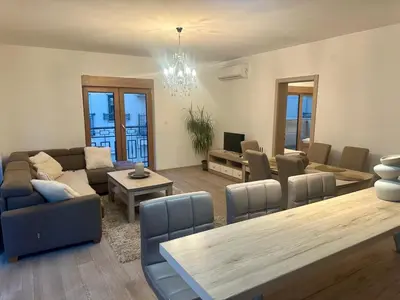 a living room with a table and a dining room at The Coastal Charm in Pržno