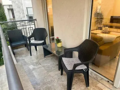 a balcony with three chairs and a table on a building at The Coastal Charm in Pržno