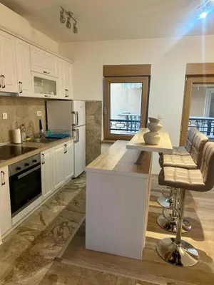 a large kitchen with white cabinets and a counter top at The Coastal Charm in Pržno