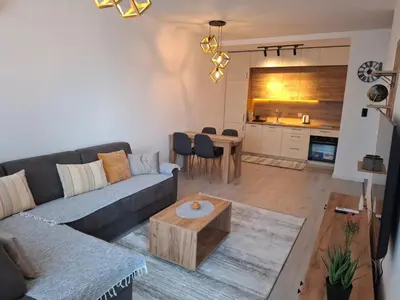 a living room with a couch and a table at Violin Apartment in Ulcinj