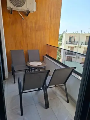 two chairs and a table on a balcony at Violin Apartment in Ulcinj