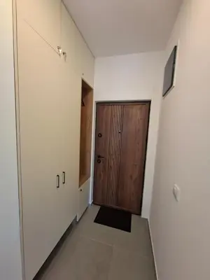 a hallway with a wooden door in a room at Violin Apartment in Ulcinj