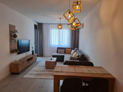 a living room with a couch and a tv at Violin Apartment in Ulcinj