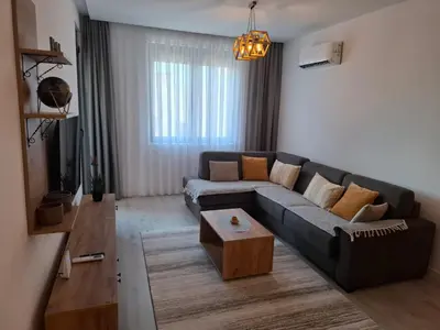 a living room with a couch and a coffee table at Violin Apartment in Ulcinj