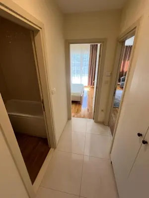 a view of a bathroom with a tub and a bedroom at Dora apartment with terrace and parking in Podgorica