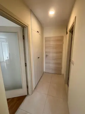 a hallway with a door and a tile floor at Dora apartment with terrace and parking in Podgorica