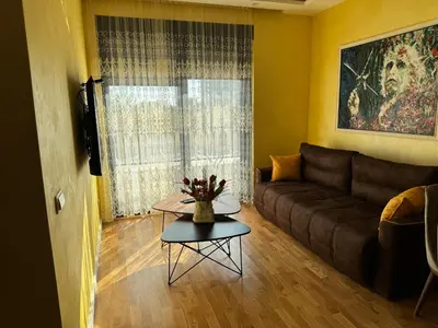a living room with a couch and a table at Harmony Apartment 2 in Bar